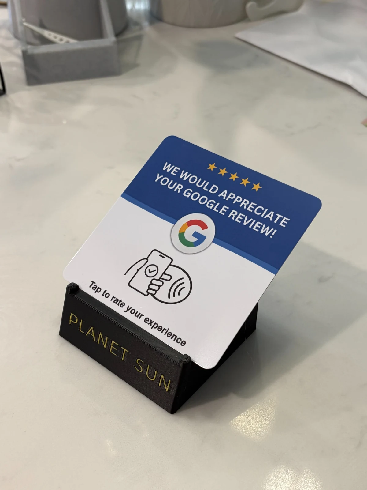 Google review NFC card displayed in a custom black stand