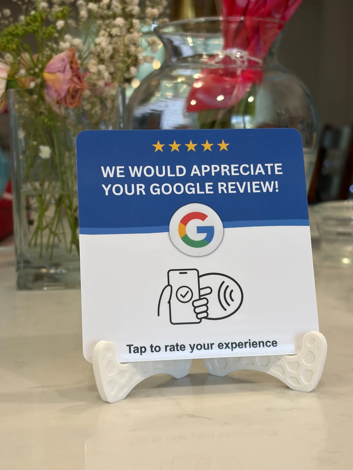 Premium Google review NFC card displayed with plants in the background